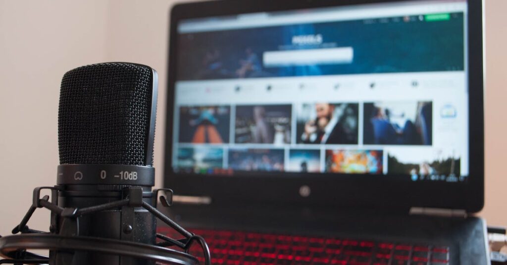 Close-up of a microphone and laptop on a desk suitable for home recording or podcasting.